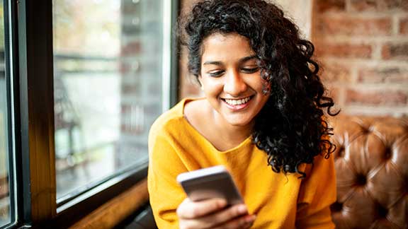 Women Smiling at Her Phone